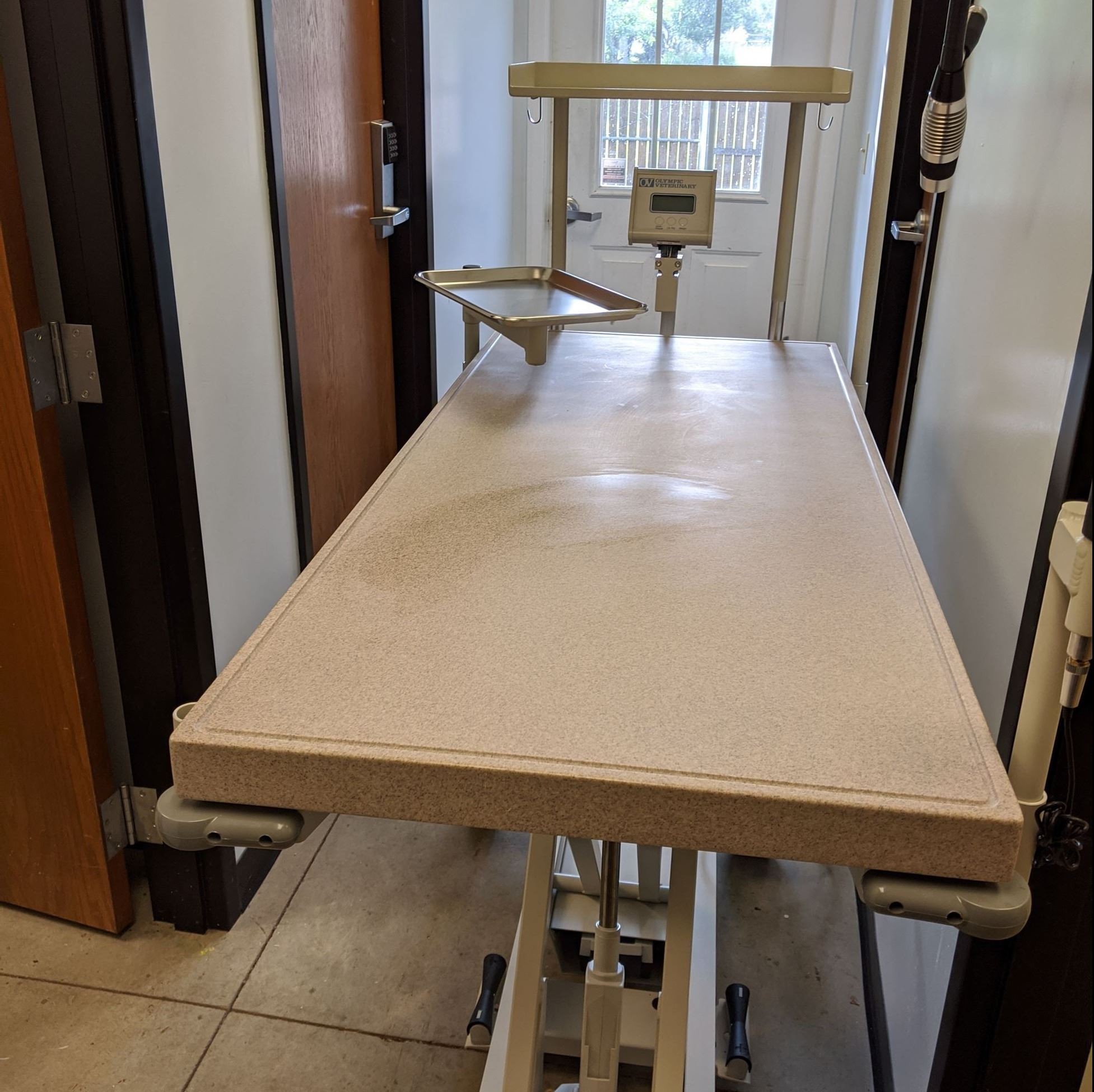 A large white table featuring a sink, designed for practical use in a kitchen or workspace setting